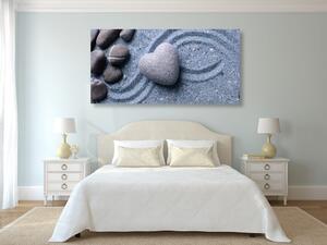 Kép szív alakú kő homokban