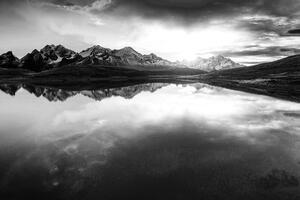 Fotótapéta naplemente egy hegyi tó felett fekete fehérben