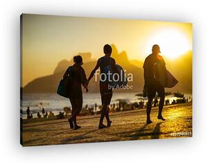 Scenic sunset silhouettes walking with surfboards along the boardwalk in front of Ipanema Beach in Rio de Janeiro, Brazil (vászonkép)