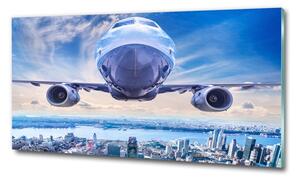 Üvegkép falra Plane a város felett