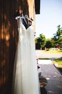 Művészeti fotózás Beautiful white wedding dress hanging elegantly, Wirestock, (26.7 x 40 cm)