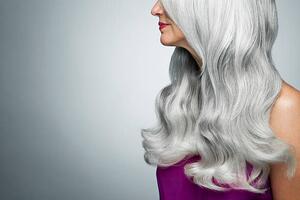 Fotográfia Cropped profile of a woman with long, gray hair., Andreas Kuehn, (40 x 26.7 cm)