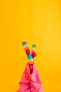 Fotográfia Woman wearing colorful socks against yellow, Westend61, (26.7 x 40 cm)