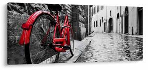 Egy vörös kerék képe egy macskaköves utcán (120x50 cm)