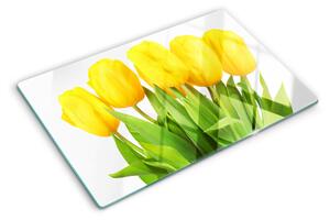 Üveg vágódeszka fényképpel Sárga tulipánok zöld háttér előtt