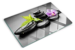 Üveg vágódeszka Kövek és orchidea a háttérben