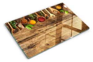 Üveg vágódeszka fényképpel Fűszerek és gyógynövények fa háttéren