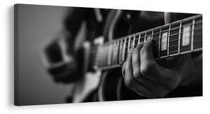 Kép ujjak a gitárhúrokon