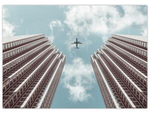 Repülőgép az épületek között képe (70x50 cm)
