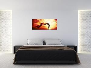 Kép - egy nő sziluettje a naplementében (120x50 cm)