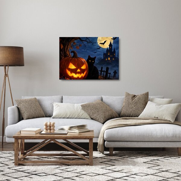Üveg kép - Fekete macska egy világító halloweeni tök mellett (70x50 cm)