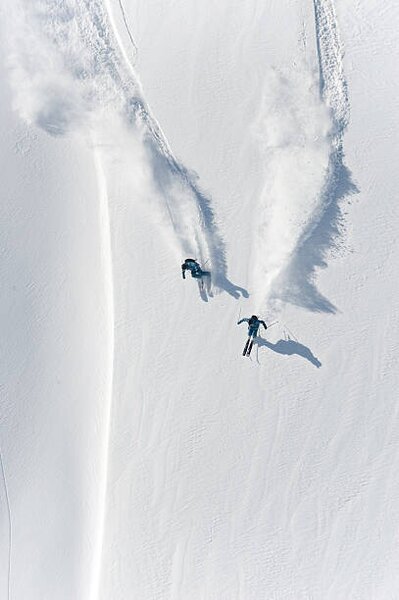 Fotográfia Aerial view of two skiers skiing, Creativaimage, (26.7 x 40 cm)