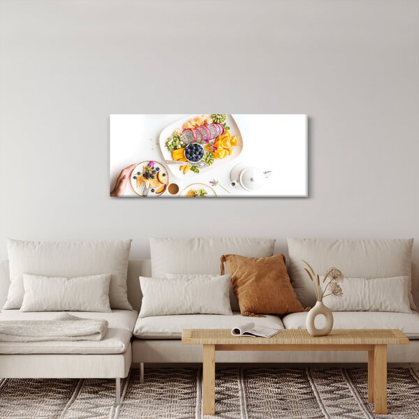 Tányérok gyümölcsökkel az asztalon képe (120x50 cm)
