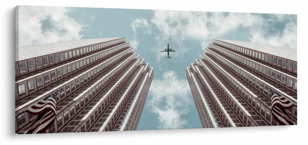 Repülőgép az épületek között képe (120x50 cm)