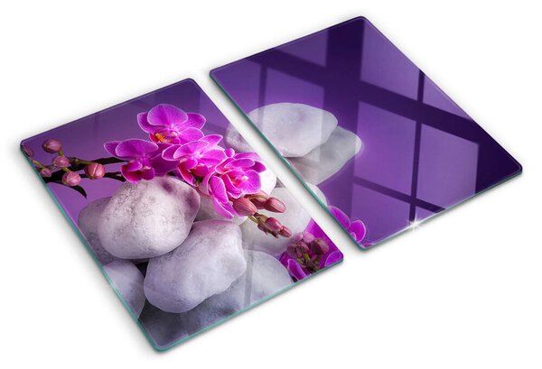 Üveg vágódeszka fényképpel Orchidea virágok kövek hátterében
