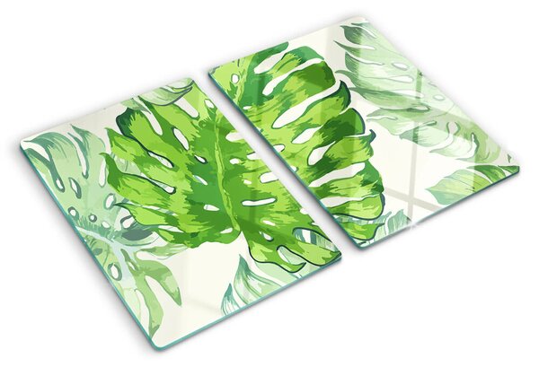 Üveg vágódeszka fényképpel Monstera levelek világos háttér előtt
