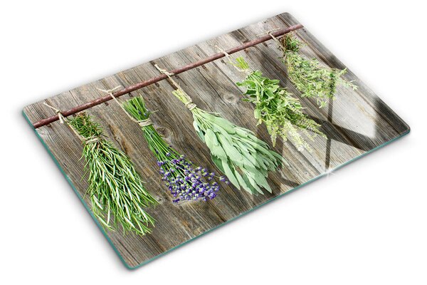 Edzett üveg vágódeszka Gyógynövények fa háttéren
