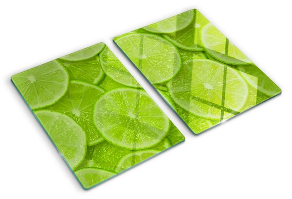 Üveg vágódeszka fényképpel Lime szeletek zöld háttéren
