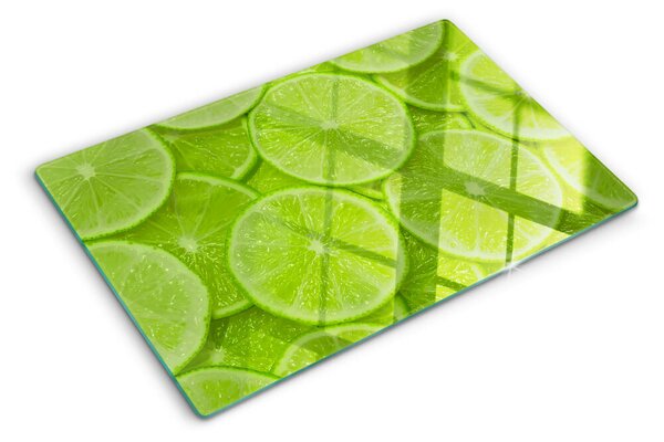 Üveg vágódeszka fényképpel Lime szeletek zöld háttéren