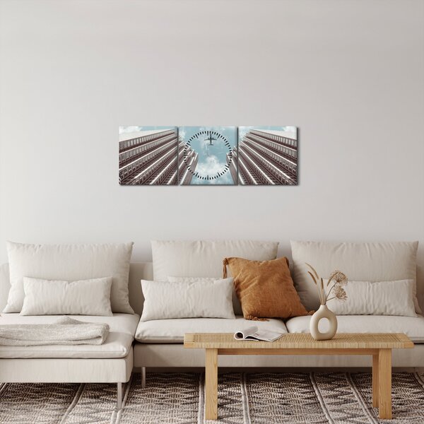 Repülőgép az épületek között képe (órával) (90x30 cm)