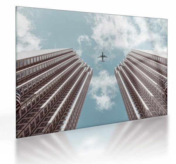 Repülőgép az épületek között képe (üvegen) (70x50 cm)