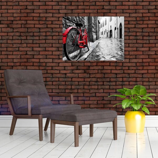 Egy vörös kerék képe egy macskaköves utcán (70x50 cm)