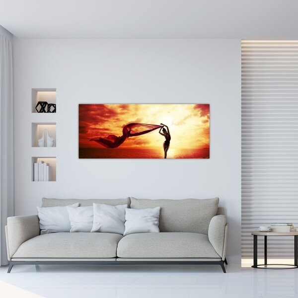 Kép - egy nő sziluettje a naplementében (120x50 cm)